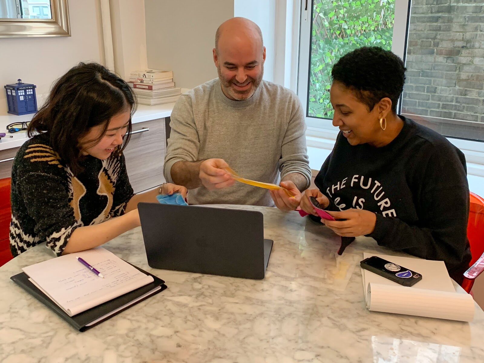 Jay Mandel working with two collaborators at a table