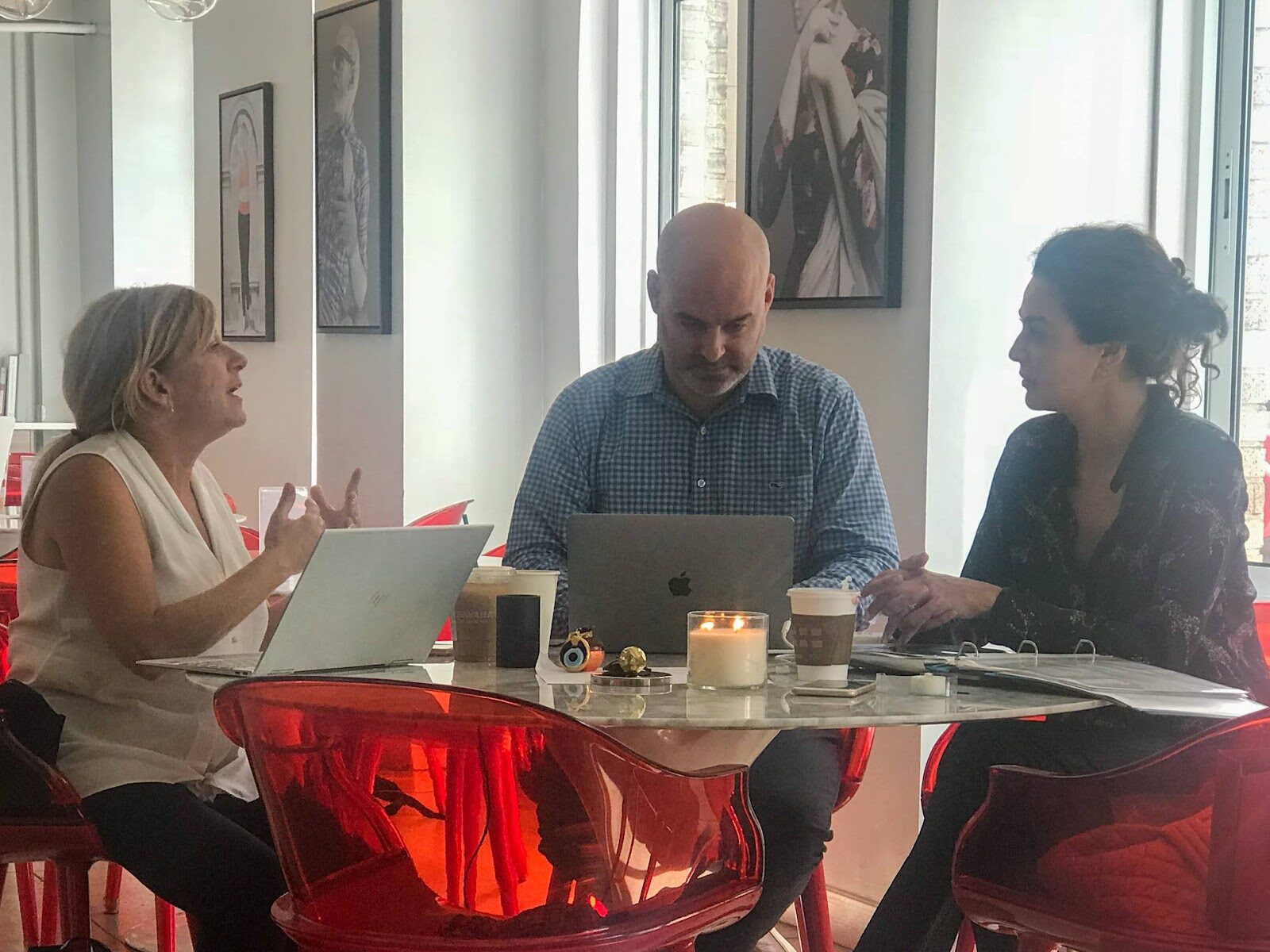 Jay collaborating with a group around a table.